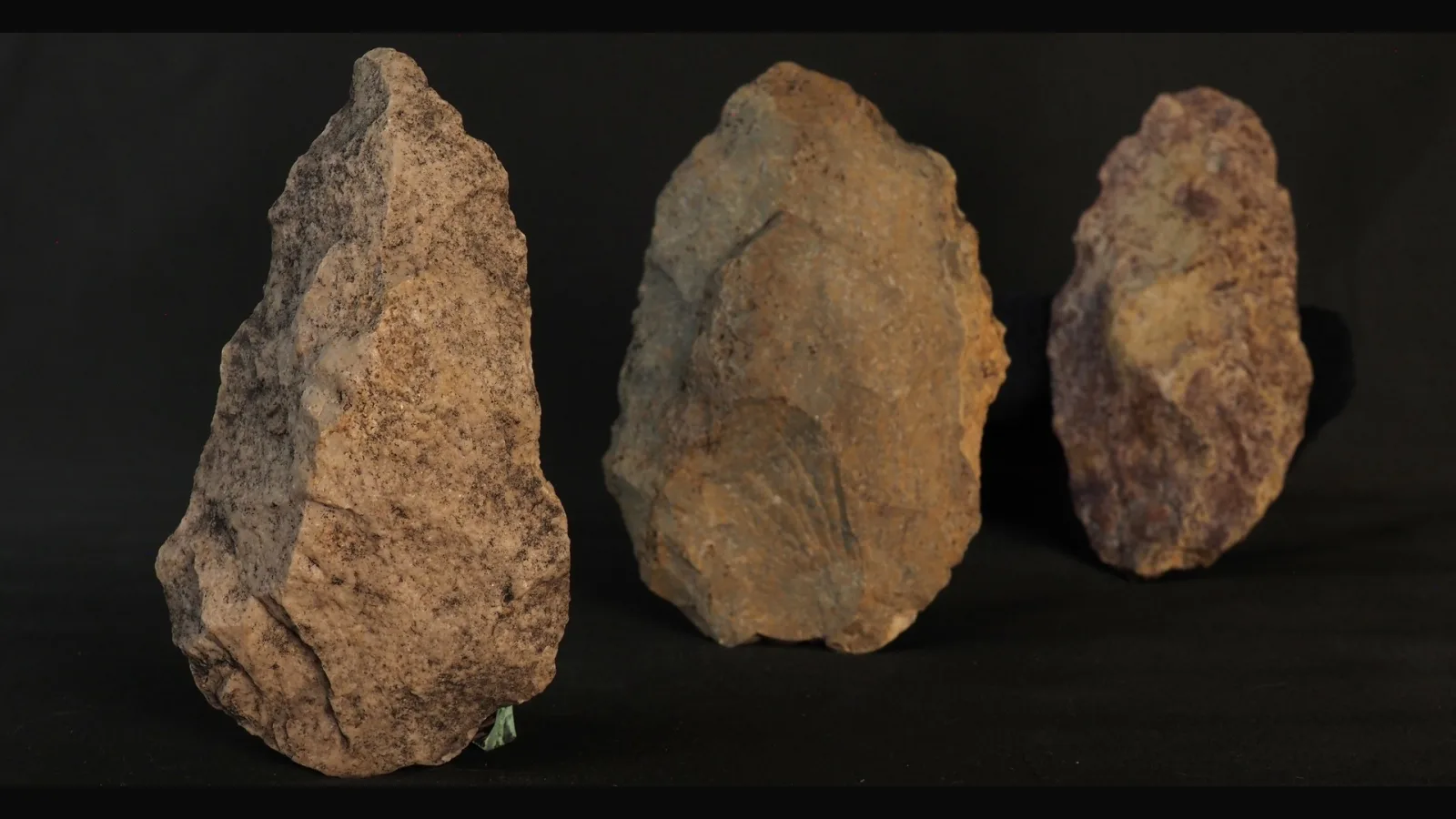 Quartzite hand-axes on laterite gravel near rock shelters, illustrating prehistoric Tamil Nadu at Attirampakkam and Gudiyam