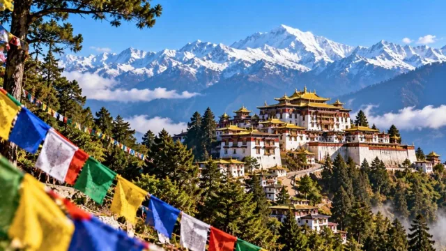 Tawang Monastery on a mountain ridge surrounded by snowy Himalayan peaks in Arunachal Pradesh