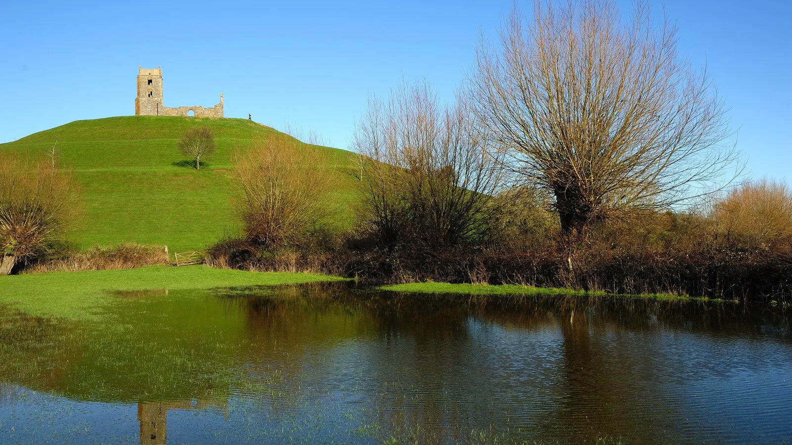 The ruined St Michael's Church on top of Burrow Mump, a green hill rising above the flooded Somerset Levels near Athelney, where Alfred the Great sheltered from the Vikings in 878