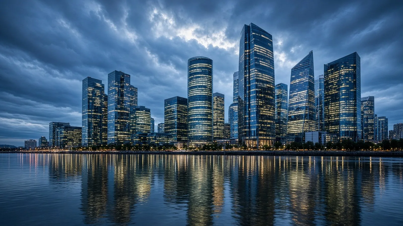Glass skyscrapers of a financial district lit at blue hour and reflected in a river under heavy clouds