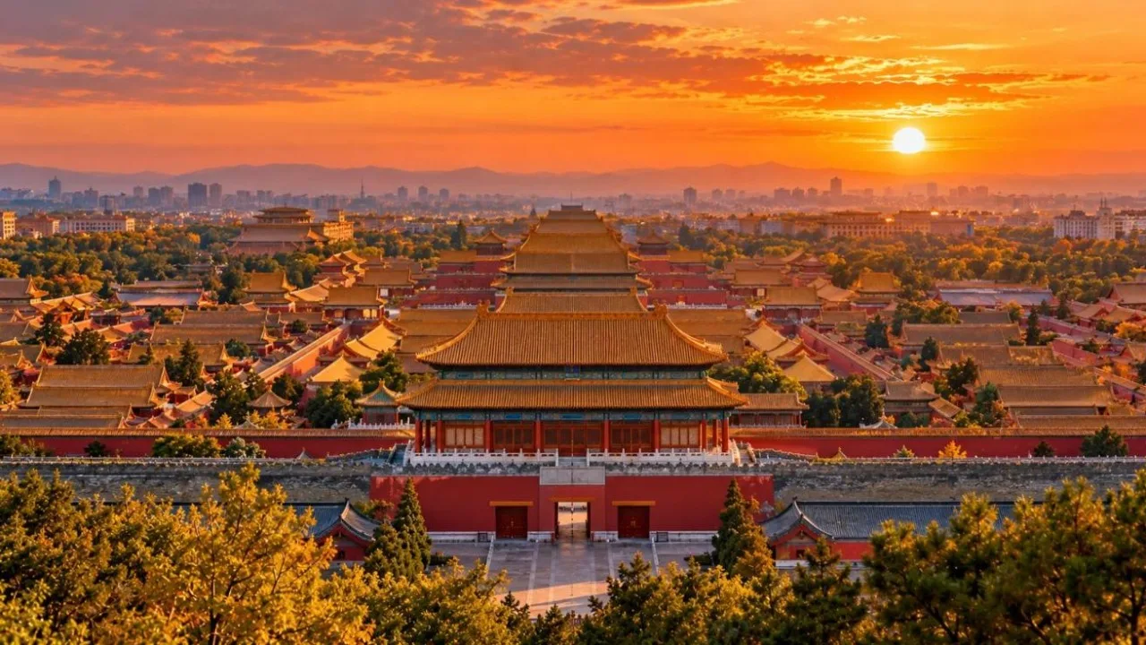 Golden roofs and red walls of the Forbidden City in Beijing seen from above at sunset